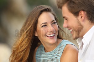 Funny couple laughing with a white perfect smile