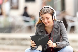 Girl learning on line with a tablet and headphones (1)