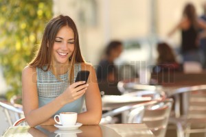 Girl texting on the phone in a restaurant