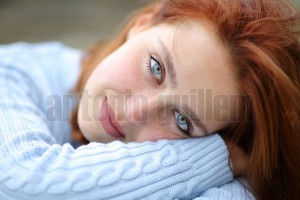 Portrait of a beautiful woman with blue eyes looking at camera