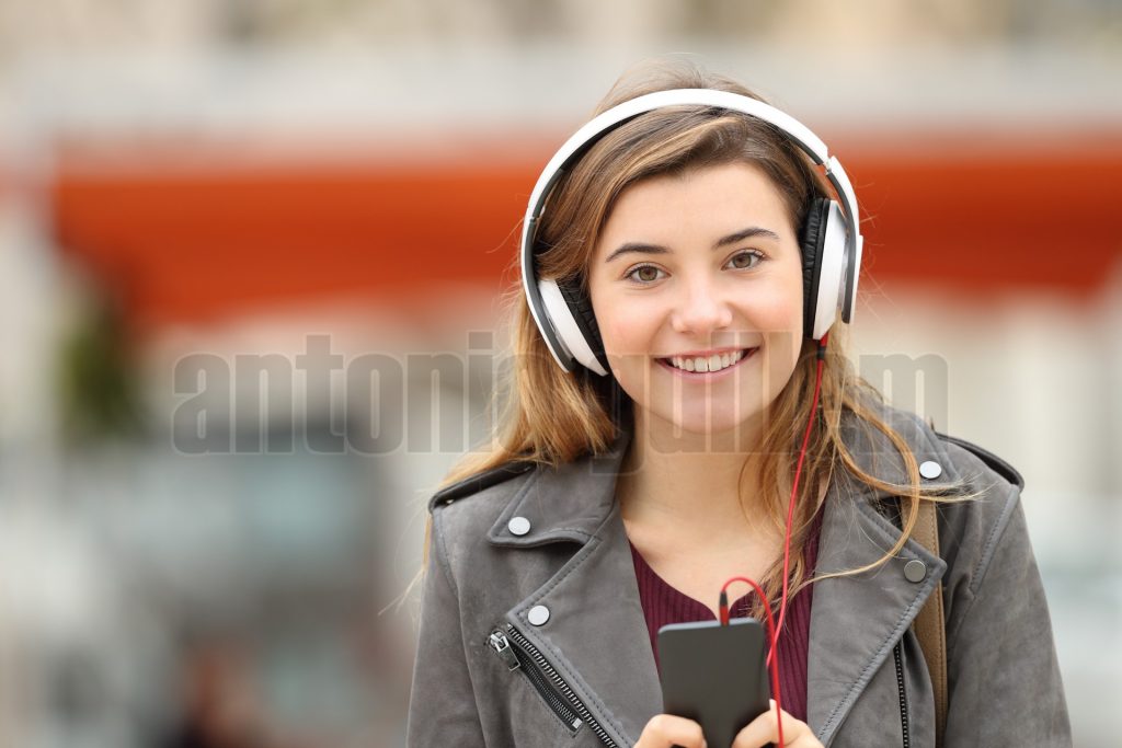 Girl listening music and looking at you
