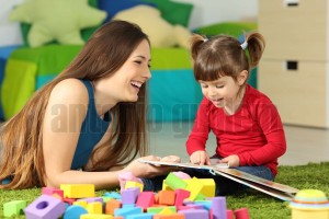 Mother and toddler playing with a book (2)